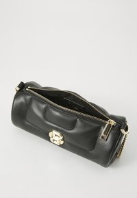 Black leather bag with gold hardware, zip closure, and a rounded shape. Features a textured surface with a subtle embossed logo detail.