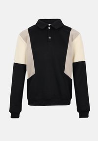 Pull-over à manches longues avec design en blocs de couleur noir, beige et crème, comportant un col et deux boutons-pression argentés au niveau du cou.
