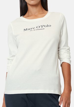 Long-sleeve cream t-shirt made of soft fabric featuring a dark blue logo print "Marc O'Polo" and "est. in Stockholm" on the front.