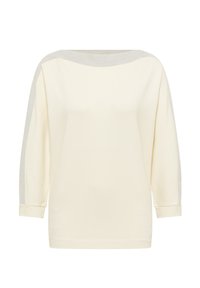 Pitkähihainen kerma väri toppi, jossa on venepääntie ja hopeanvärinen kimalteinen viimeistely olkapäillä ja hihoissa, taitetut hihansuut.