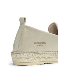 Beige suede espadrille with braided jute sole, featuring a looped back tab and embossed "FRED MARTIN" branding on the side.