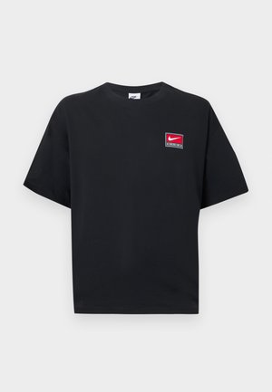 Black short-sleeve Nike t-shirt with crew neck, featuring a small red and white Nike logo patch on the upper left chest.