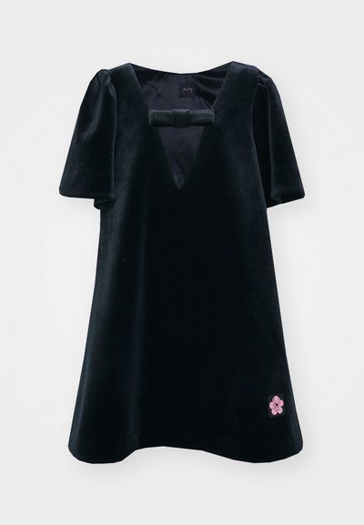 Black velvet dress with short puff sleeves and a V-neck. Features a front bow detail and a pink floral patch on the lower hem.