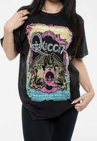Black cotton t-shirt featuring "A Night at the Opera" Queen graphic. Design includes colorful crown and eagle motifs, with vintage styling.