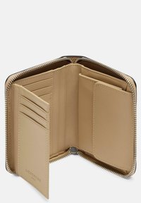 Beżowy skórzany portfel z zamkiem błyskawicznym, wieloma miejscami na karty i dwiema większymi kieszeniami. Charakteryzuje się gładką teksturą i przeszyciami.