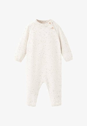 Combinaison tricotée couleur crème avec texture tachetée, manches longues et deux boutons en bois à l'épaule pour un habillage facile.