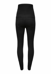 Leggings noirs taille haute en tissu extensible. Équipés d'une surface lisse et de deux poches arrière. Design ajusté à travers les jambes.