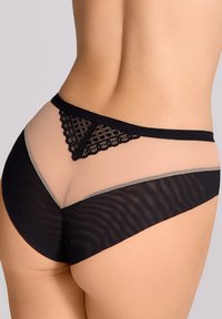 Czarne siateczkowe majtki z koronkowym wykończeniem, mające trójkątny kształt z tyłu, gładką czarną talię i półprzezroczystą strukturę.