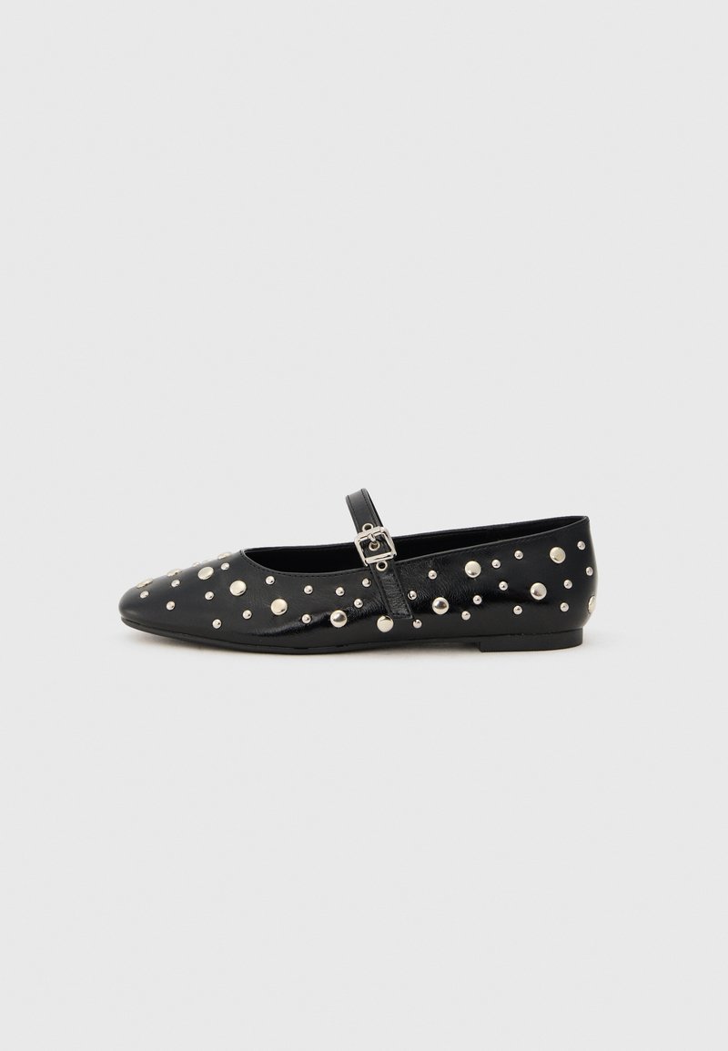 Black leather ballet flats with a pointed toe, adorned with silver studs and a side buckle strap. Textured surface with a flat sole.