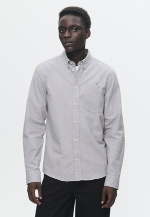 Gray button-up shirt with a pocket and embroidered logo, featuring a classic collar and long sleeves, made of textured fabric.