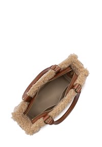 Beige shearling handbag with brown leather handles. Zippered closure, spacious interior with a neutral lining, and soft texture.