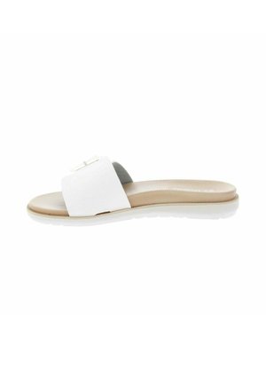 Mule blanche avec large bride et semelle beige rembourrée sur fond blanc, vue de côté.