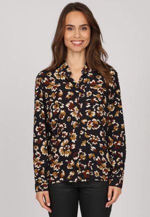 Chemise à boutons florale noire, ornée de motifs floraux blancs, bruns et rouille. Manches longues et col. Texture lisse.