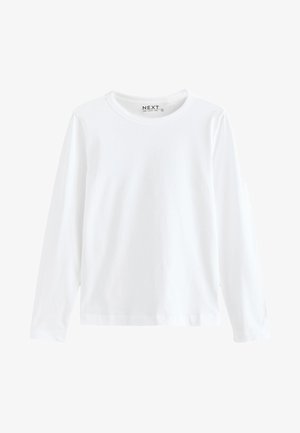 Bijela majica dugih rukava od pamuka s okruglim izrezom. Ima jednostavnu, glatku teksturu bez vidljivih uzoraka ili akcenata.