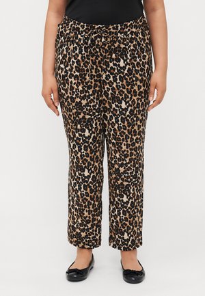 Leopard print trousers made of soft fabric with an elastic waistband, featuring a drawstring. Wide-leg design and solid black shoes.