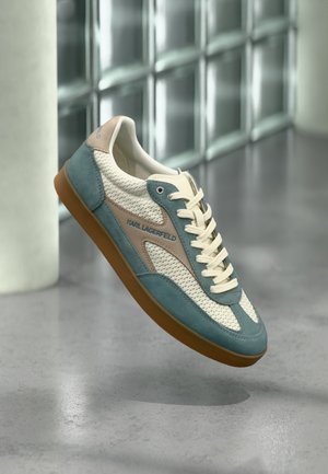Casualowy sneaker z kremową siateczką, turkusowymi akcentami z zamszu, beżowymi detalami, białymi sznurowadłami i gumową podeszwą, z logo "KARL LAGERFELD" po boku.