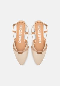 Beige pointed-toe slingback shoes with a shiny gold accent band and a small heel. Features a strap with an adjustable buckle.