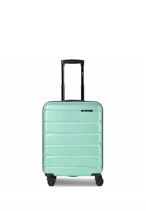 Valise rigide vert menthe avec poignée télescopique noire et quatre roues pivotantes, debout sur fond blanc.