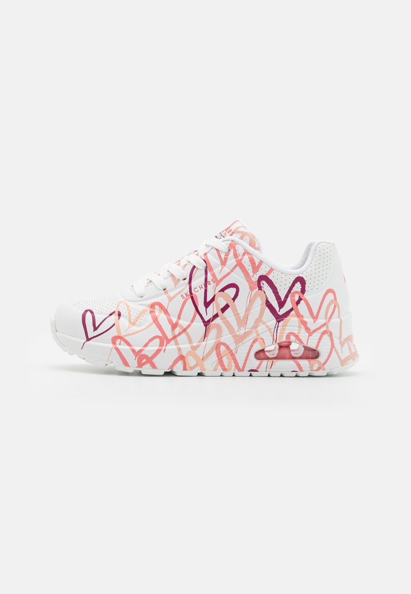 White sneakers featuring a textured upper with multicolored heart patterns in shades of pink and purple, and a visible air cushioning unit.