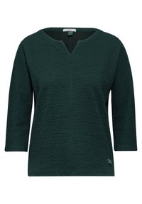 Haut vert foncé à manches trois-quarts, avec une surface texturée et un décolleté en V. Étiquette de marque visible au niveau du décolleté.