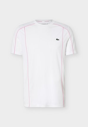 Λευκό κοντομάνικο μπλουζάκι με ροζ ραφές και μικρό πράσινο λογότυπο κροκόδειλου στο αριστερό στήθος.