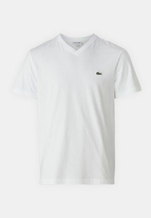 White cotton t-shirt with a V-neck, short sleeves, and a small green crocodile logo on the left chest. Simple and lightweight design.