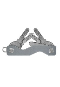 Multi-tool keychain made of silver metal, featuring multiple folding tools with textured grips and a simple, curved design.