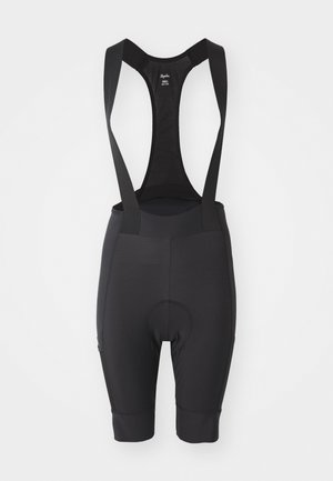 Černé cyklistické šortky s kšandami, nastavitelné popruhy, polstrovaným sedlem a elastickým materiálem pro maximální komfort. Hladká textura s těsným střihem.