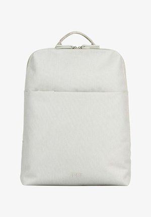 Light gray rectangular backpack with top handle, front zipper pocket, and brand logo "JOST" at the bottom center.