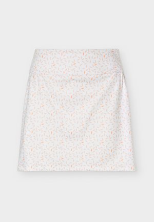 Jupe blanche trapèze taille haute, décorée de petits motifs de feuilles pêches et marron clair dispersés.