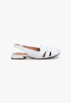 White leather slingback flat shoe with cut-out details and a low square heel, viewed from the side against a white background.