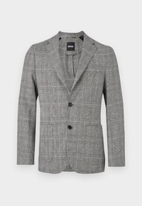 Μαύρο και άσπρο καρό σακάκι ανδρικό με δύο μαύρα κουμπιά και πέτο με σχισμή, παρουσιασμένο σε λευκό φόντο.