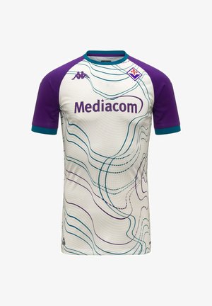 Maglia da calcio bianca e viola a maniche corte con colletto bordato di turchese, motivi a linee ondulate, logo Mediacom e stemma del club Fiorentina sul petto.