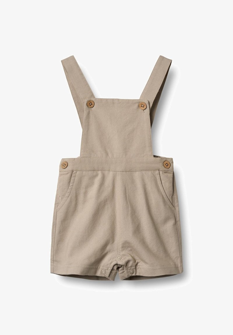 Monos de algodón beige con tirantes ajustables, dos bolsillos frontales, botones de madera y un diseño corto. Textura suave, estilo casual.