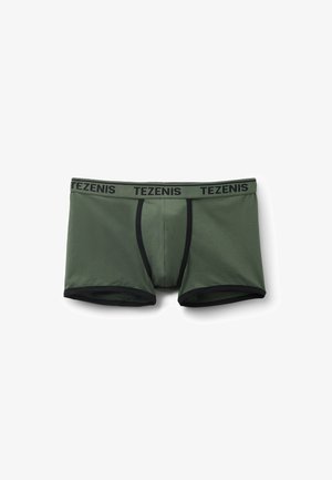 Dunkelgrüne Baumwoll-Boxershorts mit einem schwarzen elastischen Bund, der das "TEZENIS"-Logo trägt. Glatte Textur und figurbetontes Design.