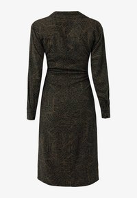Robe noire à manches longues et longueur genoux avec un motif géométrique de lignes beiges formant des formes irrégulières, vue de dos.