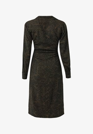 Vestido negro de manga larga, hasta la rodilla, con un patrón geométrico de líneas beige que forman formas irregulares, visto desde atrás.