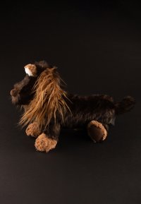 Plush lion toy with dark brown body, light brown limbs, and detailed shaggy mane. Features round eyes and a soft, textured finish.