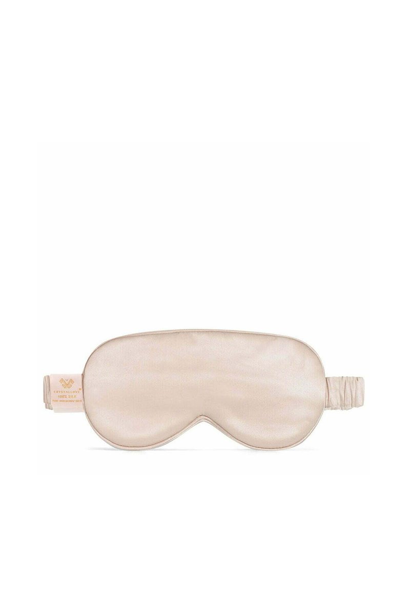 Seiden-Schlafmaske in hellbeige mit abgerundeten Kanten. Verfügt über eine weiche Textur, ein elastisches Band und ein Etikett mit der Aufschrift "100% Seide".