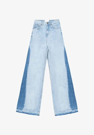 Vaqueros de pierna ancha de mezclilla azul claro con un diseño de patchwork que incluye una sección azul más oscuro en cada lado y dobladillos rectos.