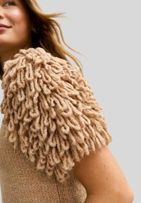 Knit sweater with beige textured body and puff sleeves made of looped yarn, featuring a soft, fuzzy appearance and a fitted silhouette.
