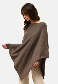 Brązowy wełniany ponczo o szerokim, luźnym kroju, z otwartymi bokami i długimi rękawami. Miękka tekstura i minimalistyczny design.