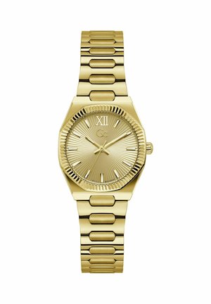 Kullavärvi käekell flööditud raamiga, päikesekiiri meenutava sihverplaadiga, rooma numbriga XII, tikk-tunnimärkidega ja metallist linkidega käerihmaga.