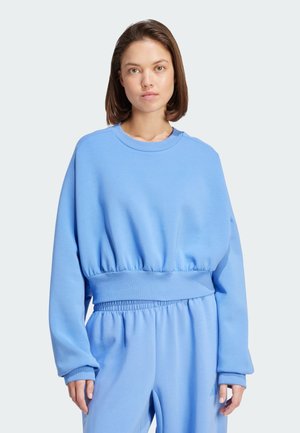 Blauwe sweatshirt met een strakke, elastische taille en brede mouwen. Zachte stof met een ronde hals en een ontspannen pasvorm.