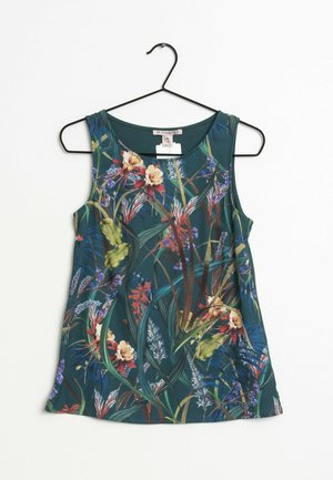 Haut sans manches vert foncé avec un motif floral et feuillage multicolore, encolure ronde, suspendu à un cintre noir sur fond blanc.
