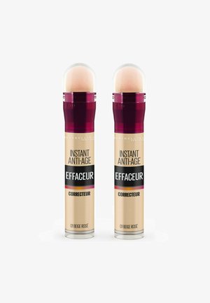 Deux correcteurs Maybelline Instant Anti-Age dans un emballage cylindrique, d'une couleur rose beige clair, avec un applicateur arrondi et une étiquette noire frappante.