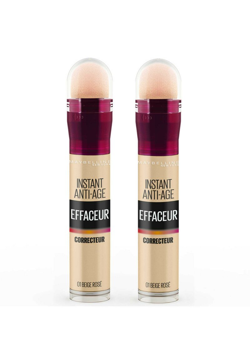 Deux correcteurs Maybelline Instant Anti-Age dans un emballage cylindrique, d'une couleur rose beige clair, avec un applicateur arrondi et une étiquette noire frappante.