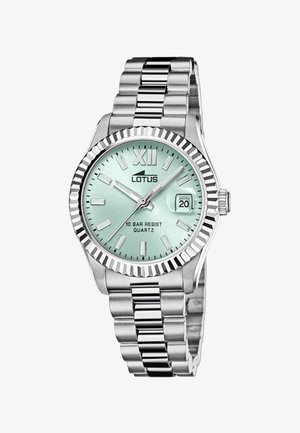 Orologio in acciaio inox argento con quadrante verde menta, indicazione della data alle 3 e un ghiera texturizzata con il numero romano XII.