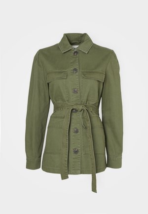Olive green, belted jacket made of cotton denim. Features a collar, button closure, two front pockets, and long sleeves with cuffs.