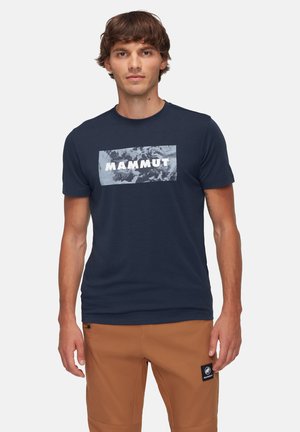 Navy blue short-sleeve t-shirt featuring a light gray graphic with "MAMMUT" text. Smooth fabric and crew neck design.